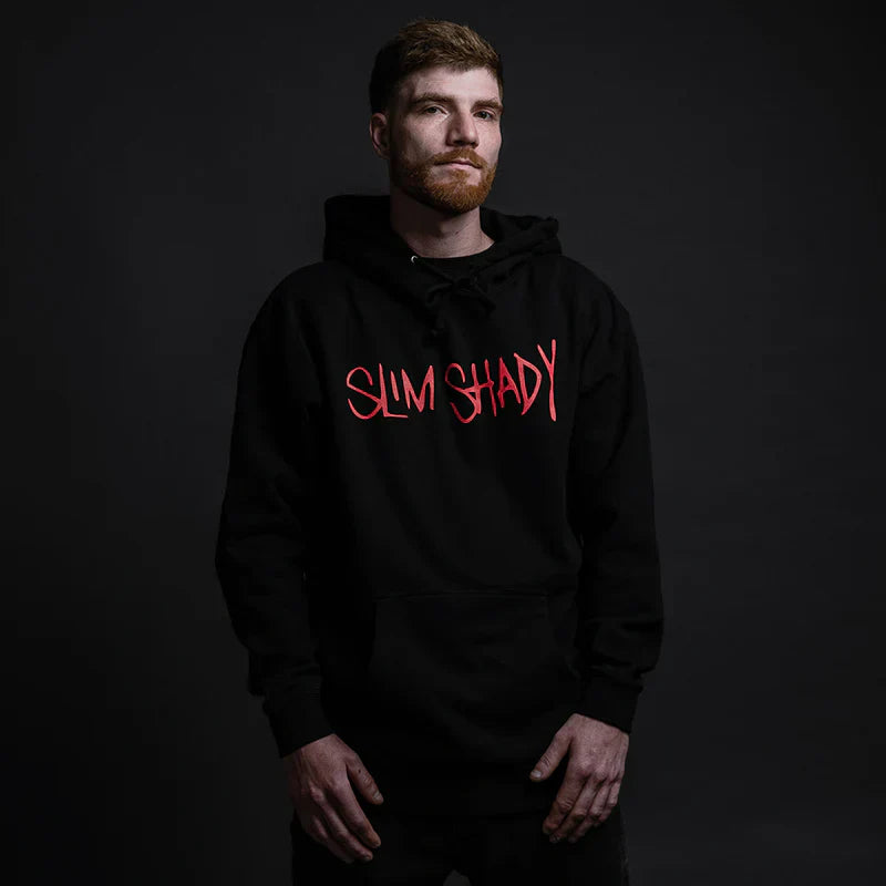 Person wearing a black hoodie with 'SLIM SHADY' in red text on a dark background