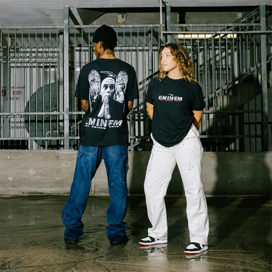Two people wearing Eminem t-shirts in an urban setting